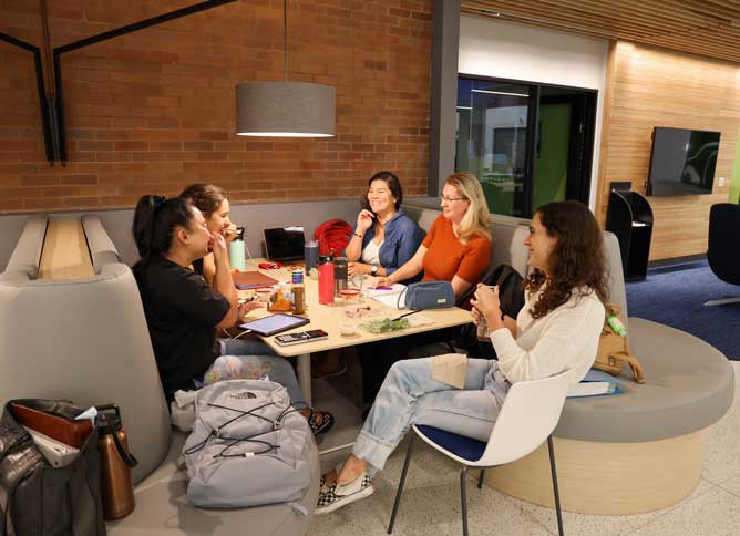 A group of Oakton College students sitting and eating at Oakton's newly renovated cafeteria.