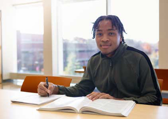 Student studying with a book.