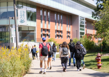 A group of Oakton College students walk in front of the Lee Center.