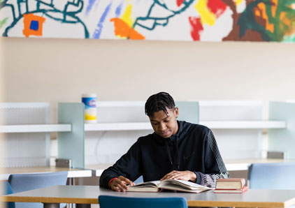 Student (appears to be male) in the library.