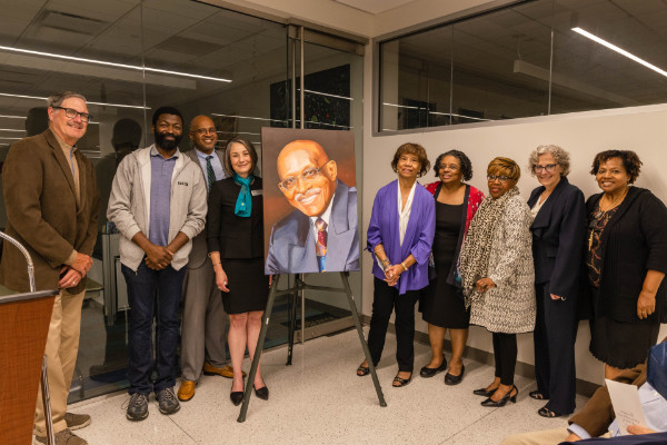 (L-R): Oakton Trustee Bill Stafford, Associate Professor of mathematics Mario Borha, Provost and Vice President for Academic Affairs Ileo Lott, President Joianne L. Smith, Gerri Sizemore, Andrea Lawrence, and Oakton Trustees Martha Burns, Vice Chair Wendy Yanow, and Marie Lynn Toussaint surround the newly unveiled portrait of Emory Williams.