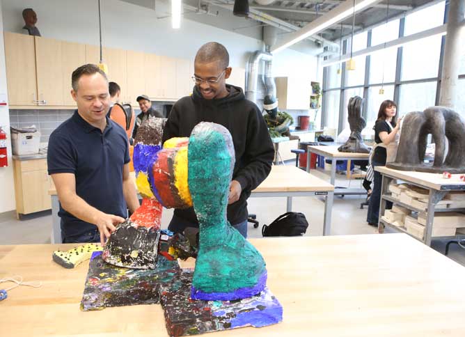 Student and ceramics instructor in the studio.